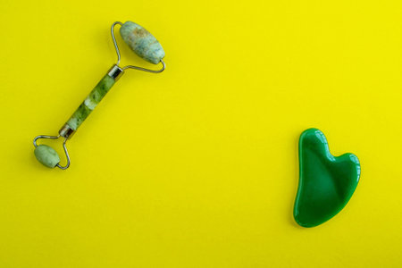 Jade massagers on a yellow background. background with copy space. background for advertising.の写真素材