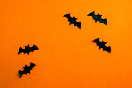 Halloween background, paper black bats on orange paper. Background for advertising.の写真素材