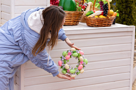 The decor of the street for Easter. A bright Easter egg wreath in the decoration of the house...