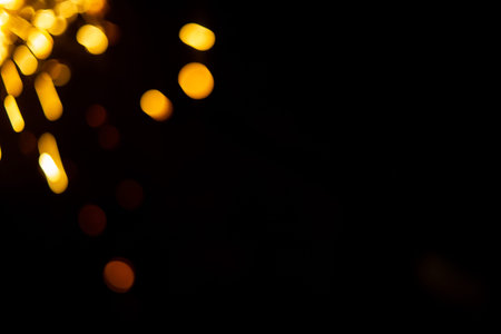 The side of the sparklers on a black background. Bokeh in the blur. Bengali fire burning on a dark...