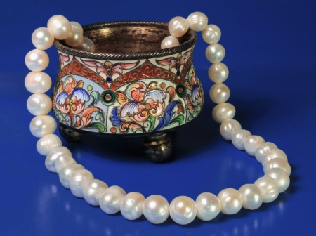 Silver box of the 19th eyelid and pearl necklace on a dark blue backgroundの写真素材