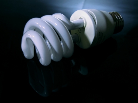 The energy saving bulb is against a dark backgroundの写真素材