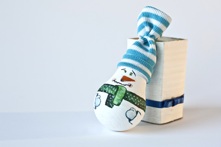 Handmade Christmas toy stylized as a snowman, recycled from used lamp, painted and created by the children, children's creativity,の写真素材