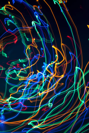Abstract background. Bright multi-colored lines on a dark background. The lines move chaotically...