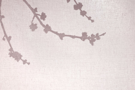 abstract background. Silhouette of branches behind a light cotton fabric. Branch shadows on beige fabric background, minimalism, early spring concept.の写真素材