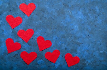 festive romantic concept. red hearts made of fabric on a dark blue background with copy space. March 8, birthday, Valentine's Day. mockup for postcardsの写真素材