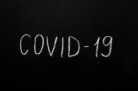 Coronavirus concept. The inscription in white chalk on a black slate background. Epidemic of coronavirus infection. Pandemic. with copy space or image placementの写真素材