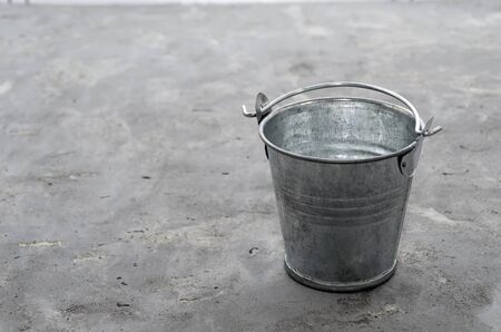 mini galvanized bucket gray background. Aluminum bucket for flower garden for the manufacture of accessories for the home and garden. gardening floriculture planting plants summer season seedlingsの写真素材