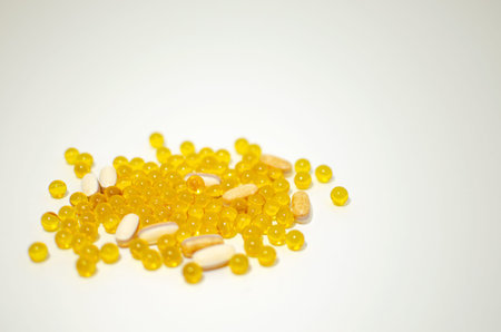 Health. Close-up of a tablet with clear capsules or soft gel capsules with omega-3 and vitamins c...