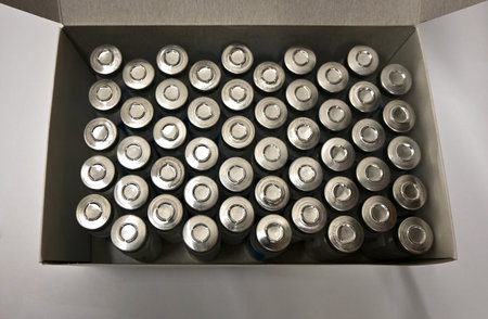 Vaccination epidemic. many glass test tubes with medicine with metal caps in a cardboard box on a...