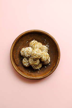 Homemade raw vegan coconut and lemon truffles over pink background. energy balls. healthy sweets. snack. protein dietの写真素材