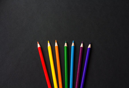 Colour pencils isolated on black background