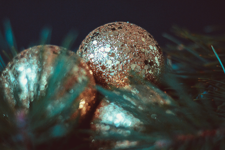 Spruce branch with three golden Christmas balls on a blueの写真素材