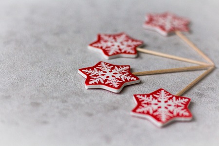 Christmas decoration: red snowflakes on a stick on a lightの写真素材