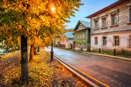 Old Russian houses with carved windows along Sovetskaya Street from stone and wood on the Volga embankment in the autumn Plyos early in the morningのeditorial素材