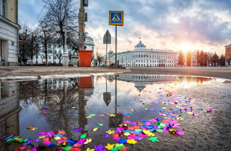 The building of the Government of the Tver region with a flag and a puddle on the asphalt and multicolored sparkles in the city of Tver on a sunny winter dayのeditorial素材