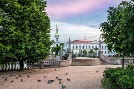 St. Nicholas Cathedral with a bell tower on the Kryukov Canal in St. Petersburg and pigeons near the steps in the early sunny morningのeditorial素材