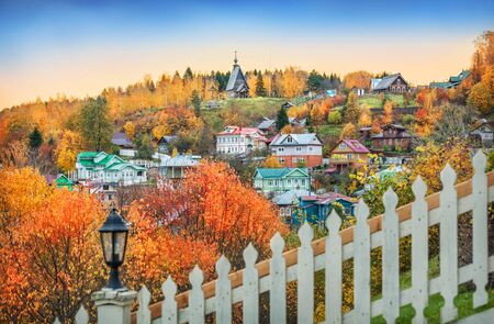 View of Levitan Mountain with a church and houses from the fence of the Krylov House in autumn Plyosの写真素材