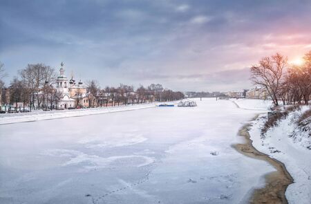 Church of Dmitry Prilutsky in Vologda on the banks of the Vologda river on a pink winter morning and snow-covered shipsの写真素材