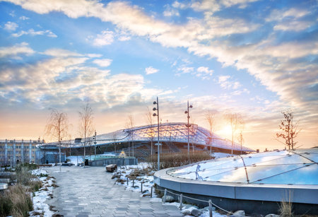 The building of the concert hall in Zaryadye in Moscow and the morning spring blue sky with the sun