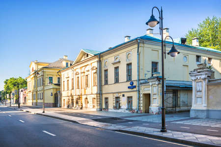 Old buildings of yellow mansions on Pyatnitskaya street in Moscow and lanterns on a summer sunny morning. Inscription: Pyatnitskaya streetのeditorial素材