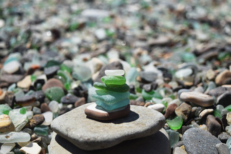 a tower of smooth multicolored glass on the seashoreの写真素材