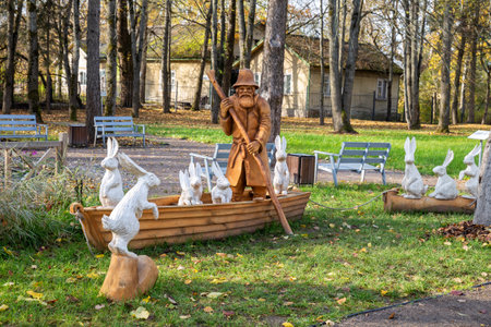 Chudovo, Russia - October 08, 2022: Wooden sculpture based on the plot of the famous poem Old Man Mazai and Hares. Author Vladimir Shkalikov, 2022. Museum-estate of NA Nekrasovのeditorial素材