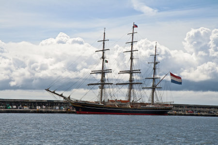Big sailing under a Dutch flag is moored in an island Fajal bayの写真素材