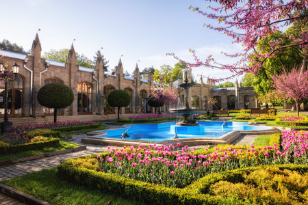 Ancient building of the Narzan Gallery with flower beds and a fountain, Kislovodsk, Russia