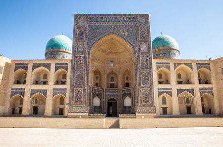 Facade of the ancient Mir-i-Arab (Miri Arab) Madrassah in the center of Bukhara. Uzbekistan