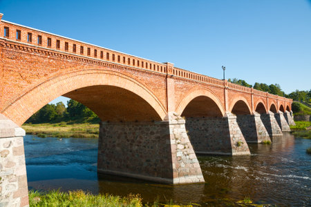 Old brick bridge across the Venta river, Kuldiga, Latviaの写真素材