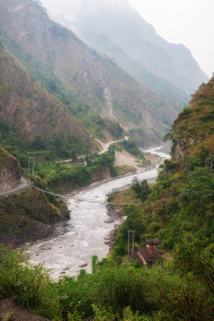 Kali Gandaki River Gorge in the morning mist. Suspension bridge over Kali Gandaki River near Tatopani Village, Nepal, Himalayasの写真素材