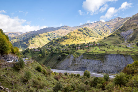Beautiful view from Georgian Military Road to village on mountainside and valley of Aragvi River
