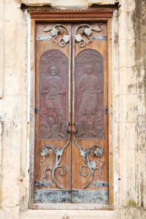 Ancient door with the image of the Holy Martyrs David and Constantine in Motsameta Monastery near Kutaisi, Georgiaの写真素材