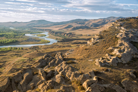 Beautiful landscape in the evening sunlight. Mtkvari river on the background of the Caucasus Mountains, view from the cave city Uplistsikhe, Georgiaの写真素材