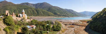 Panoramic view of Ananuri fortress, Aragvi river and Zhinvali reservoir in autumn. Low water level...