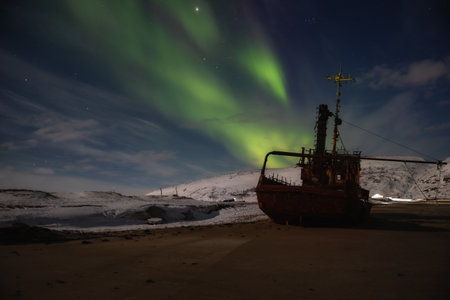 Old abandoned fishing boat under the Aurora borealis. Teriberka, Murmansk regionの写真素材