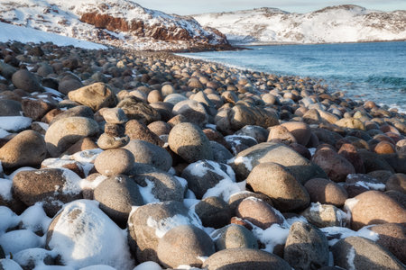 Rocky shore of the Barents Sea. The stone beach in Teriberka, Murmansk regionの写真素材