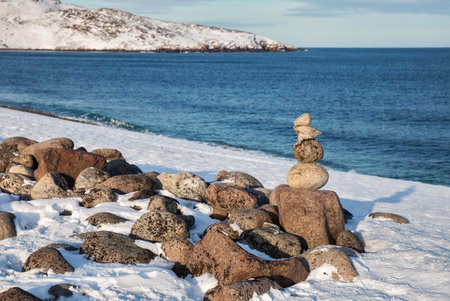 Winter on the Barents Sea. A cairn on the beach in Teriberka, Murmansk Regionの写真素材
