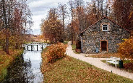 Pushkinskiye Gory, Pskov region, Russia - October 2021: Mikhailovskoye estate in autumn. Stone barn...