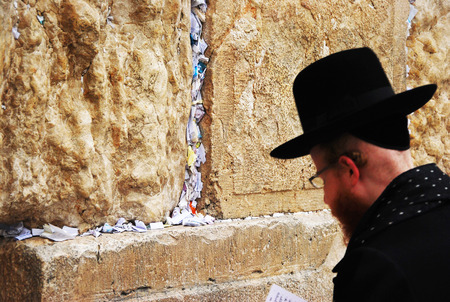 Young religious Jew prays at the Wailing Wall in Jerusalemのeditorial素材