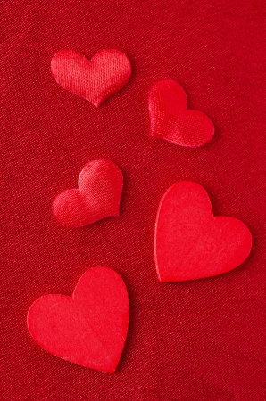 Hearts of different sizes on a red background  for Valentine's Day, closeupの写真素材