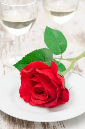 Rose on a plate and glasses of wine on Valentine's Dayの写真素材