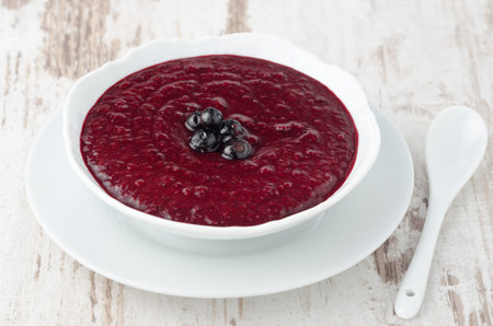 black currant jam in a white bowl horizontalの写真素材