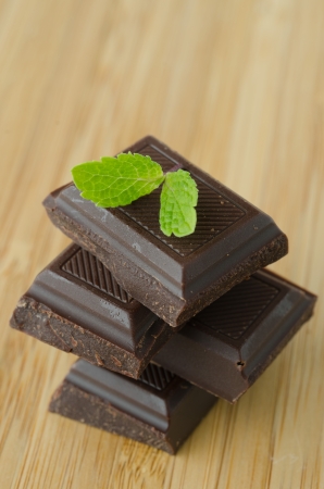 chocolate and mint on a wooden tableの写真素材