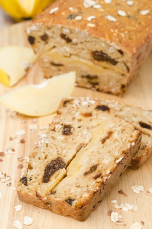 cake with oatmeal, quince and prunes on a wooden boardの写真素材