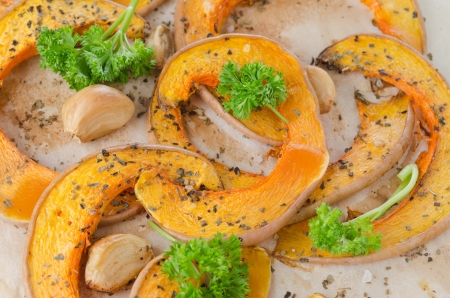 Slices of pumpkin baked with garlic closeupの写真素材