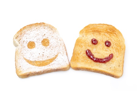Toast with a smile of powdered sugar and jam isolated on white backgroundの写真素材