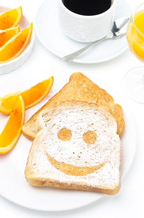 Toast with a smile of powdered sugar, fresh oranges, coffee and orange juice for breakfast closeupの写真素材