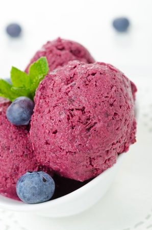refreshing blueberry sorbet in white bowl close-up verticalの写真素材